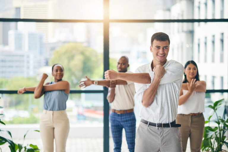 Workout, stretching and a group of business people in the office to exercise for health or mobility together. Fitness, wellness and coach training an employee team in the workplace for a warm up.